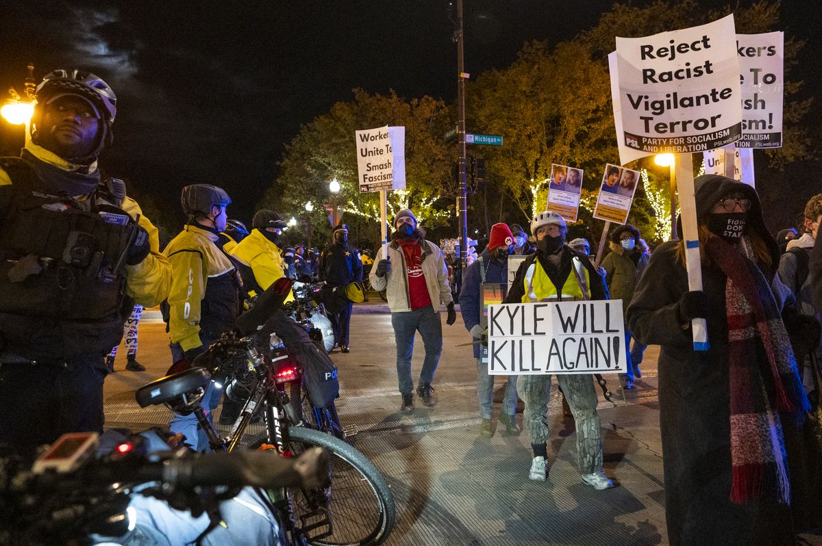 Demonstrators chant, hold signs and rally as they march around the Loop, protesting the acquittal of Kyle Rittenhouse in Kenosha, Wis., Friday night, Nov. 19, 2021. Asserting self-defense, Rittenhouse, who killed two people and injured another during a protest against police brutality in Kenosha last year, was acquitted of all charges.