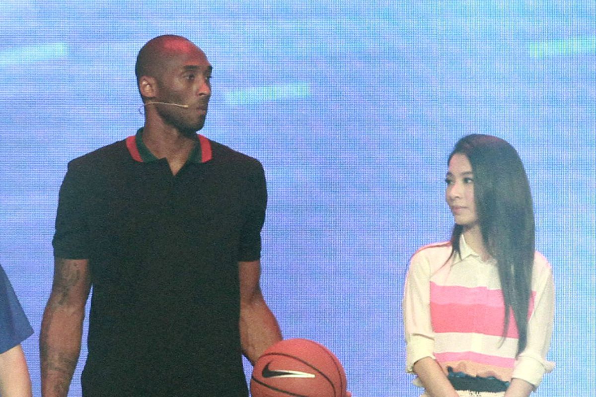 NBA player Kobe Bryant and singer Hebe (R) attend new product release conference of Lenovo on August 5, 2014 in Beijing, China.