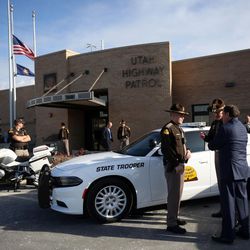 Gov. Gary Herbert talks with Utah Highway Patrol trooper Stanton Tucker and Col. Michael Rapich outside the Utah Highway Patrol's headquarters in Murray on Wednesday, Dec. 7, 2016. Herbert was there to announce his annual budget proposal.
