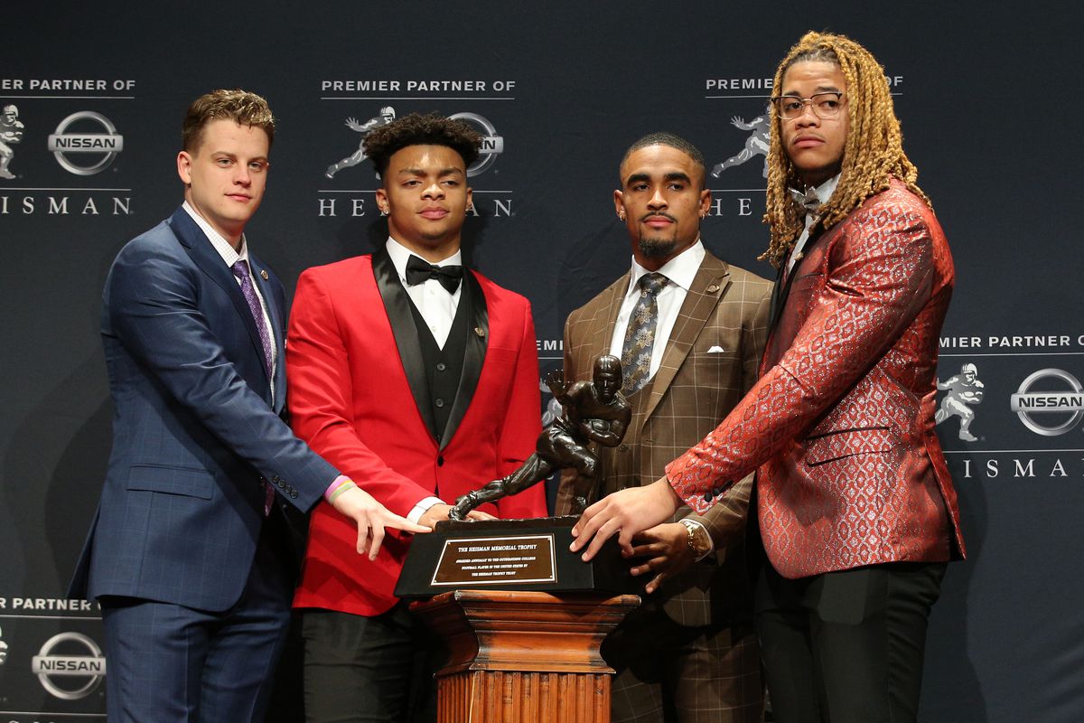 Heisman finalists LSU Tigers quarterback Joe Burrow and Ohio State Buckeyes quarterback Justin Fields and Oklahoma Sooners quarterback Jalen Hurts and Ohio State Buckeyes defensive end Chase Young pose for photos with the Heisman Trophy during a pre-ceremony press conference at the New York Marriott Marquis.