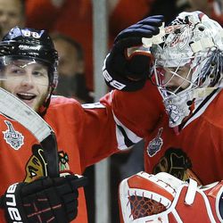 Chicago Blackhawks right wing Patrick Kane (88) celebrates with goalie Corey Crawford (50) after the Blackhawks beat the Boston Bruins 3-1 in Game 5 of the NHL hockey Stanley Cup Finals, Saturday, June 22, 2013, in Chicago. (AP Photo/Nam Y. Huh)