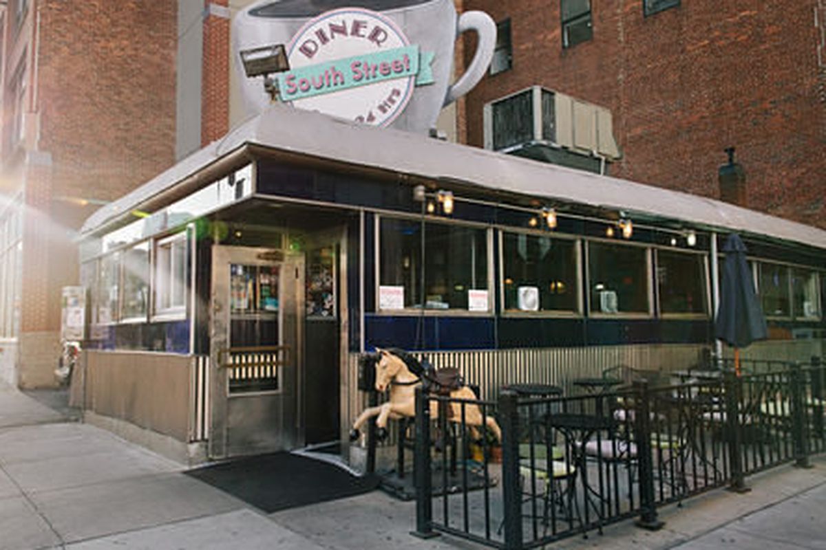 Exterior view of South Street Diner with its iconic coffee cup-shaped sign and metal siding