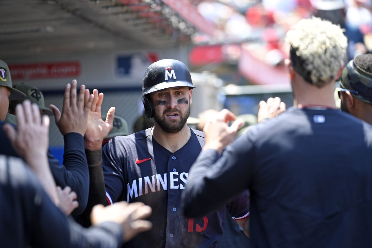 Joey Gallo of the Minnesota Twins is congratulated in the dugout after scoring a run against starting pitcher Shohei Ohtani of the Los Angeles Angels during the third inning at Angel Stadium of Anaheim on May 21, 2023 in Anaheim, California.