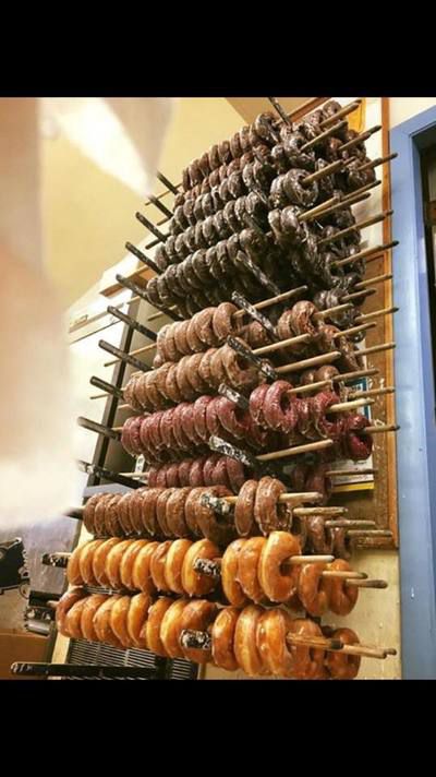 Doughnuts hanging on wooden poles