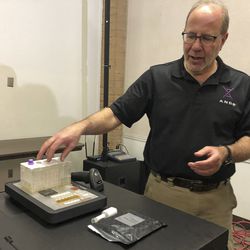 In this photo taken November 16, 2018, Stephen Meer, chief information officer from ANDE, demonstrates in Chico, Calif., his company's Rapid DNA analysis system, which is being used to try to ID victims of the Northern California wildfire. Authorities have deployed a powerful tool to aid in their race to identify the remains of 77 bodies burned in the deadly wildfire that ripped through Northern California: Rapid DNA testing that produces results in just two hours. But the technology that can match DNA to bone fragments in as little as two hours is only as effective as the numbers of people who show up to give a sample, and so far there are not nearly enough volunteers. (Sudhin Thanawala)