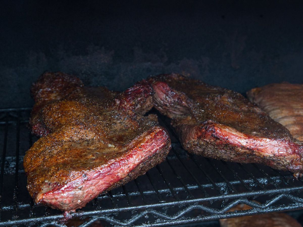 Two racks of ribs on a grill. 
