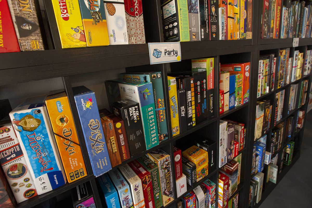 Several black shelving units filled with hundreds of game boxes.