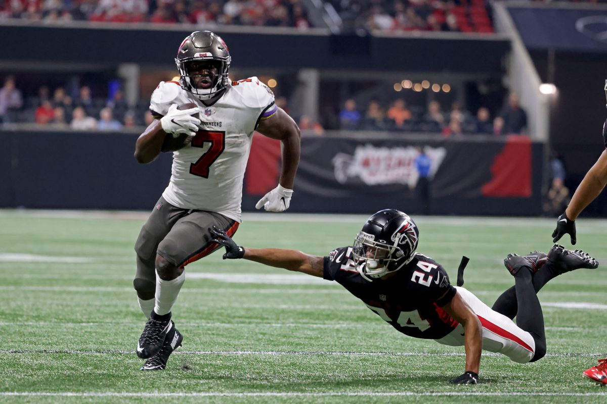 ampa Bay Buccaneers running back Leonard Fournette (7) runs against Atlanta Falcons cornerback A.J. Terrell (24) during the second half of their game against the Atlanta Falcons at Mercedes-Benz Stadium.&nbsp;