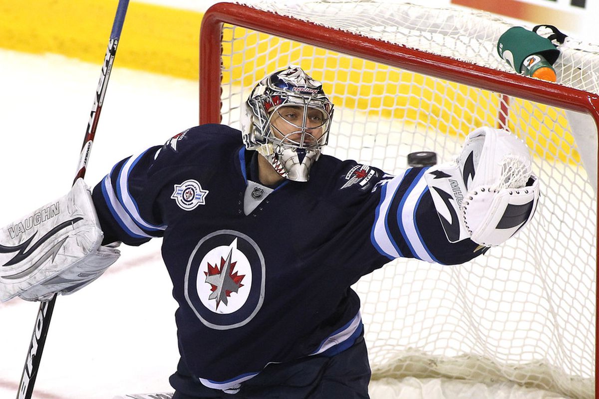 WINNIPEG, CANADA - MARCH 5: Goaltender Ondrej Pavelec #31 of the Winnipeg Jets blocks a shot on goal by the Buffalo Sabres in NHL action at the MTS Centre on March 5, 2012 in Winnipeg, Manitoba, Canada. (Photo by Marianne Helm/Getty Images)