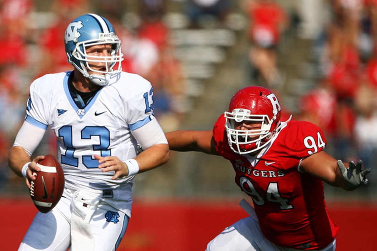 Scott Vallone of the Rutgers Scarlet Knights attempts to tackle  T.J. Yates of the North Carolina Tar Heels during a game at Rutgers Stadium on Sept. 25, 2010 in New Brunswick N.J.  (Photo by Andrew Burton/Getty Images)