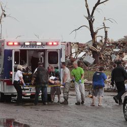 A tornado victim is loaded in an ambulance on Robinson and 142 in south Oklahoma City, Okla., Monday,  May 20, 2013.  