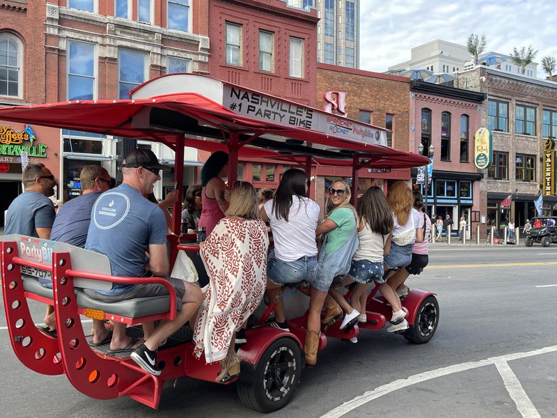 Drinkers on a mobile bar on a Nashville street. 
