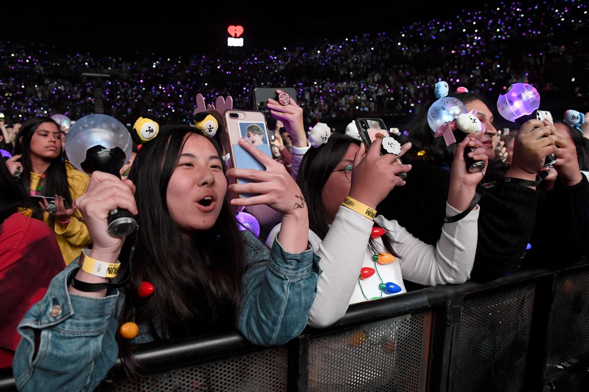 Fans watch BTS perform onstage during 102.7 KIIS FM’s Jingle Ball in 2019.