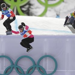 Helene Olafsen of Norway, left, Olivia Nobs of Switzerland and Faye Gulini of the USA race during the ladies snowboardcross quarterfinal at the Olympics in Vancouver Tuesday.