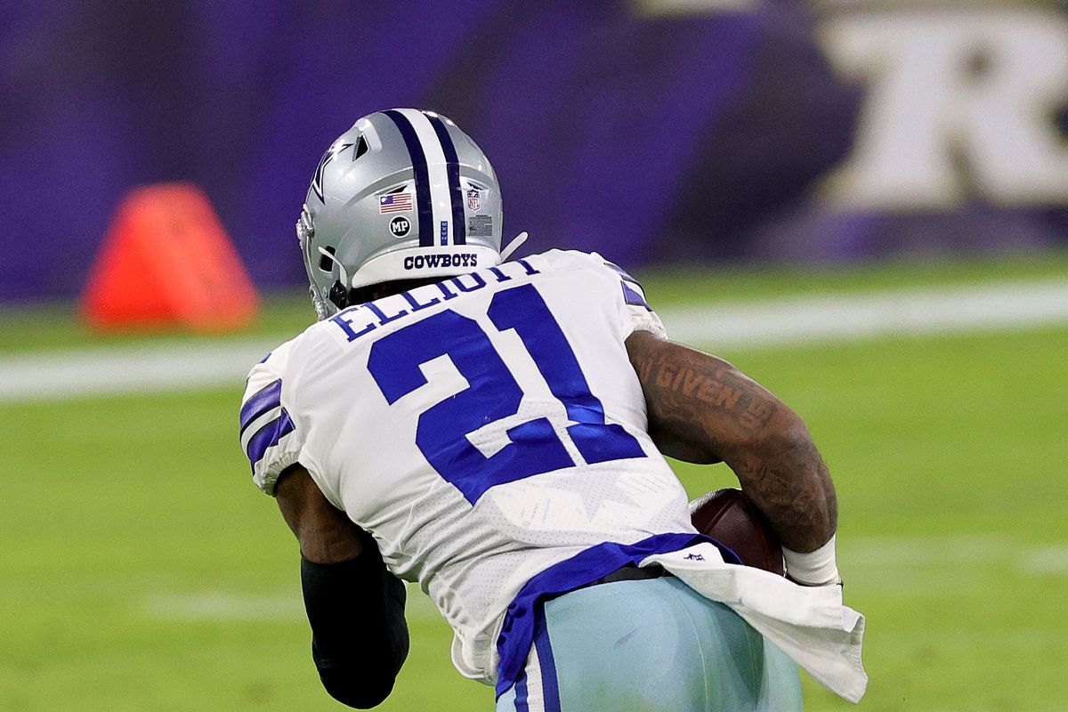 Running back Ezekiel Elliott #21 of the Dallas Cowboys carries the ball against the Baltimore Ravens at M&amp;T Bank Stadium on December 03, 2020 in Baltimore, Maryland.