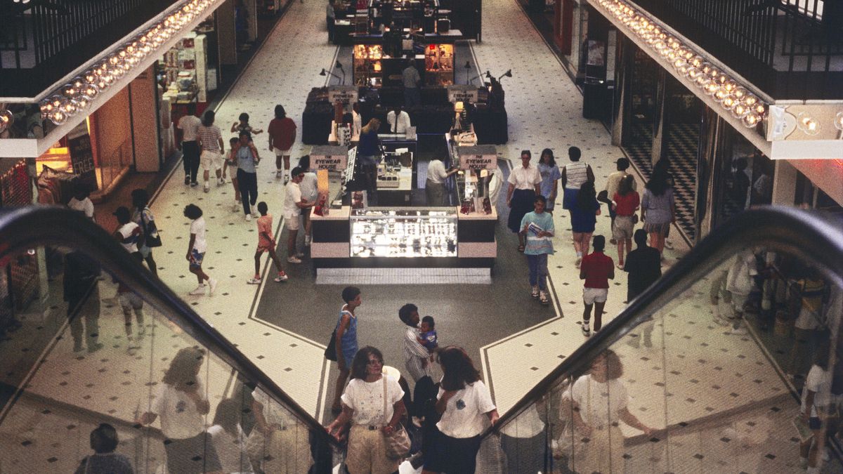 Photo from 1989 of the interior of a shopping mall looking down escalators.