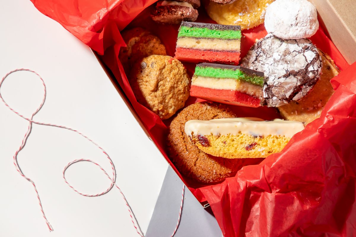Holiday cookies in a box with red tissue paper