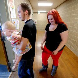 Kyle Hansen and his wife, Jerika Johnson, enter the pla room with their daughter, Rose Hansen, at the Road Home’s new Midvale Center, an emergency homeless shelter for families, on Wednesday on  March 9, 2016.