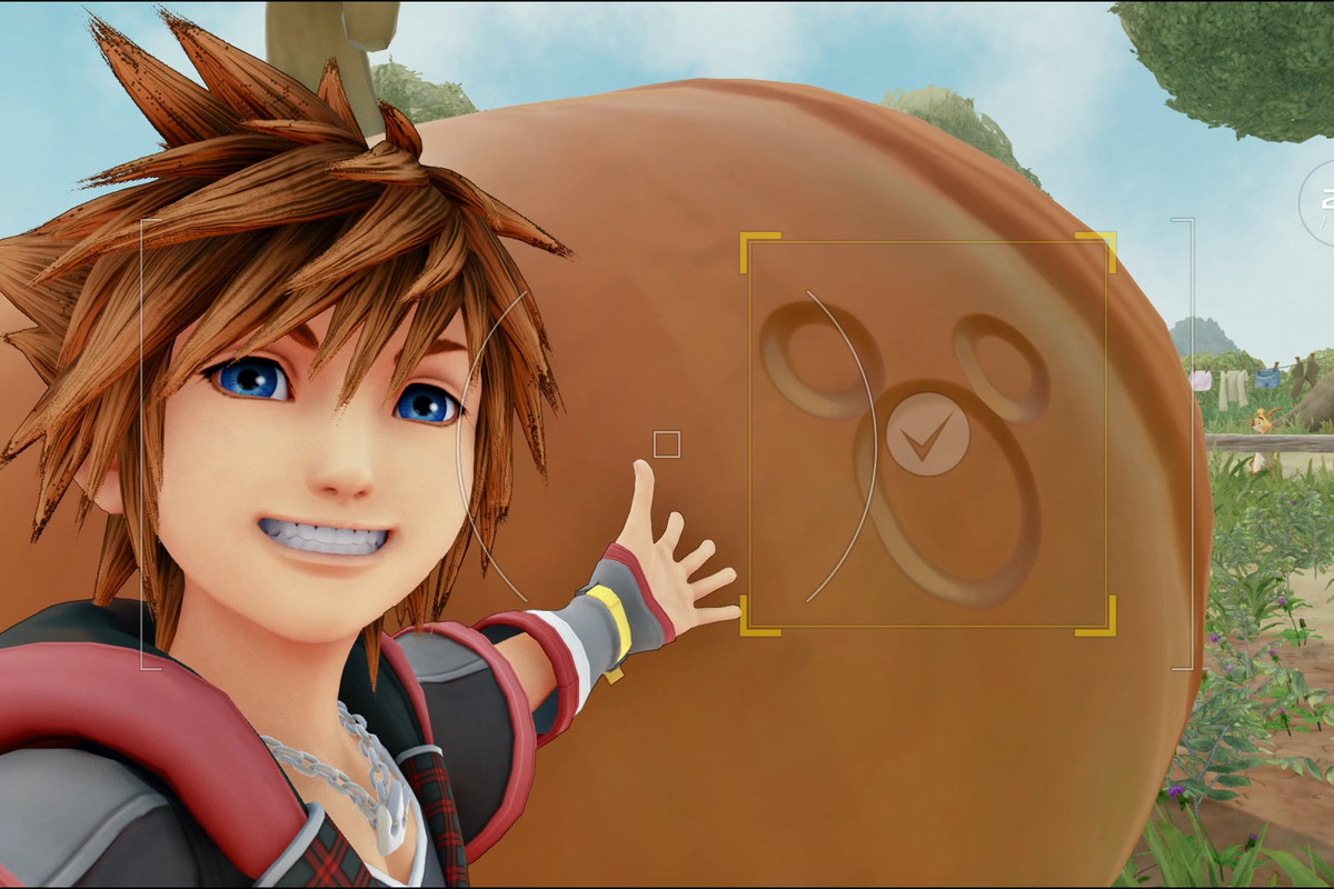 Sora smiles in front of a Lucky Emblem