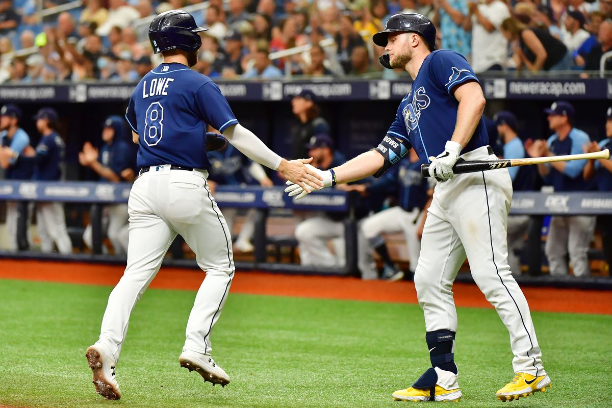 Austin Meadows #17 celebrates with Brandon Lowe #8 of the Tampa Bay Rays after a run in the third inning against the Toronto Blue Jays at Tropicana Field on September 22, 2021 in St Petersburg, Florida.