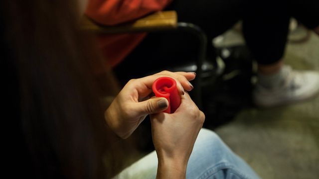 A person practicing how to fold a menstrual cup