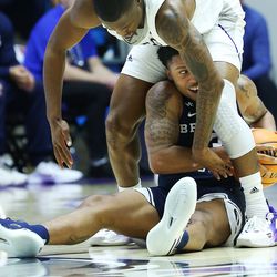 Brigham Young Cougars guard Te’Jon Lucas (3) grabs a loose ball as Weber State Wildcats guard Koby McEwen (15) defends in Ogden on Saturday, Dec. 18, 2021. BYU won 89-71.