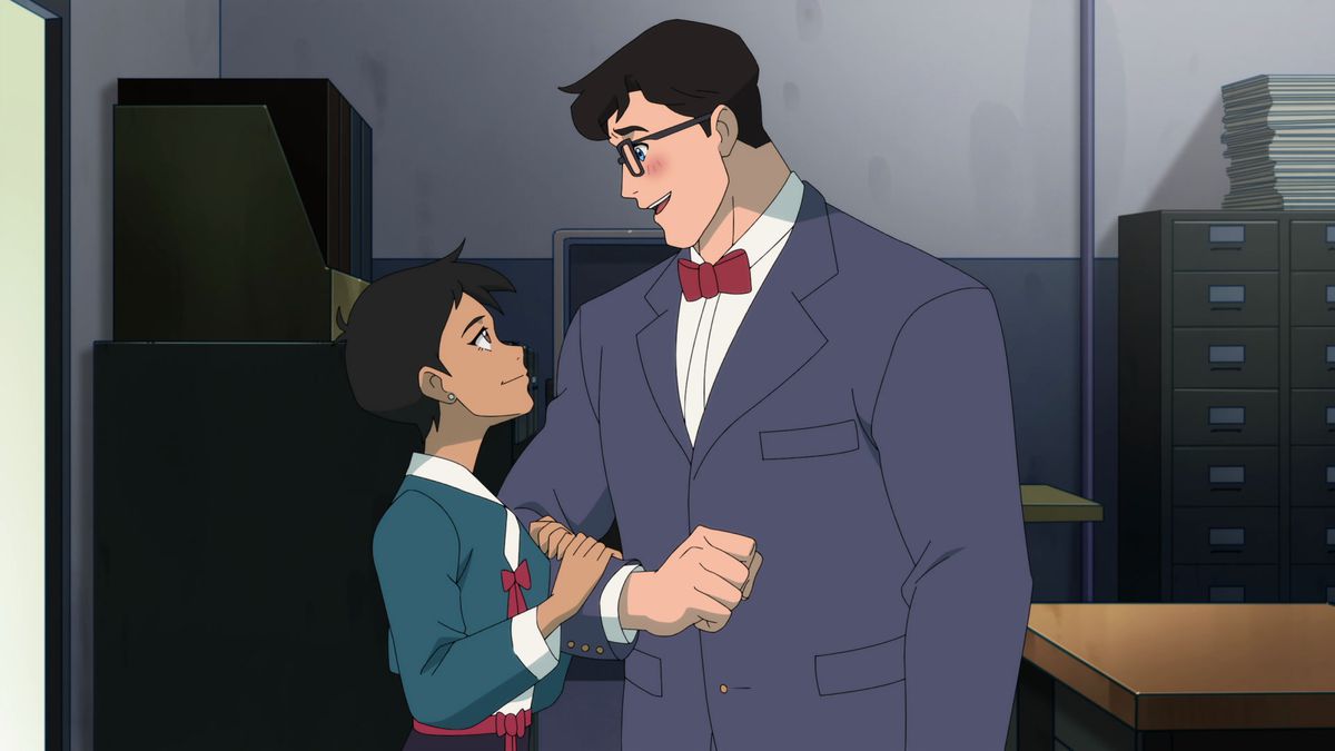Lois, holding Clark’s arm as he blushes and looks down at her in a still from My Adventures with Superman