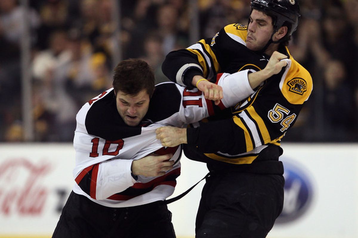 BOSTON - NOVEMBER 15:  Adam McQuaid #54 of the Boston Bruins and Rod Pelley #10 of the New Jersey Devils fight on November 15 2010 at the TD Garden in Boston Massachusetts.  (Photo by Elsa/Getty Images)