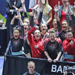 Co-head coach Greg Masden, left, and teammates react to Corrie Lothop's score of 9.90 on the bars as the University of Utah Red Rocks wins the PAC-12 gymnastics championship at the Jon M. Huntsman Center in Salt Lake City on Saturday, March 21, 2015.