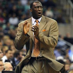Utah Jazz head coach Tyrone Corbin applauds a breakaway score by the Jazz during a game at EnergySolutions Arena on Monday, December 2, 2013.
