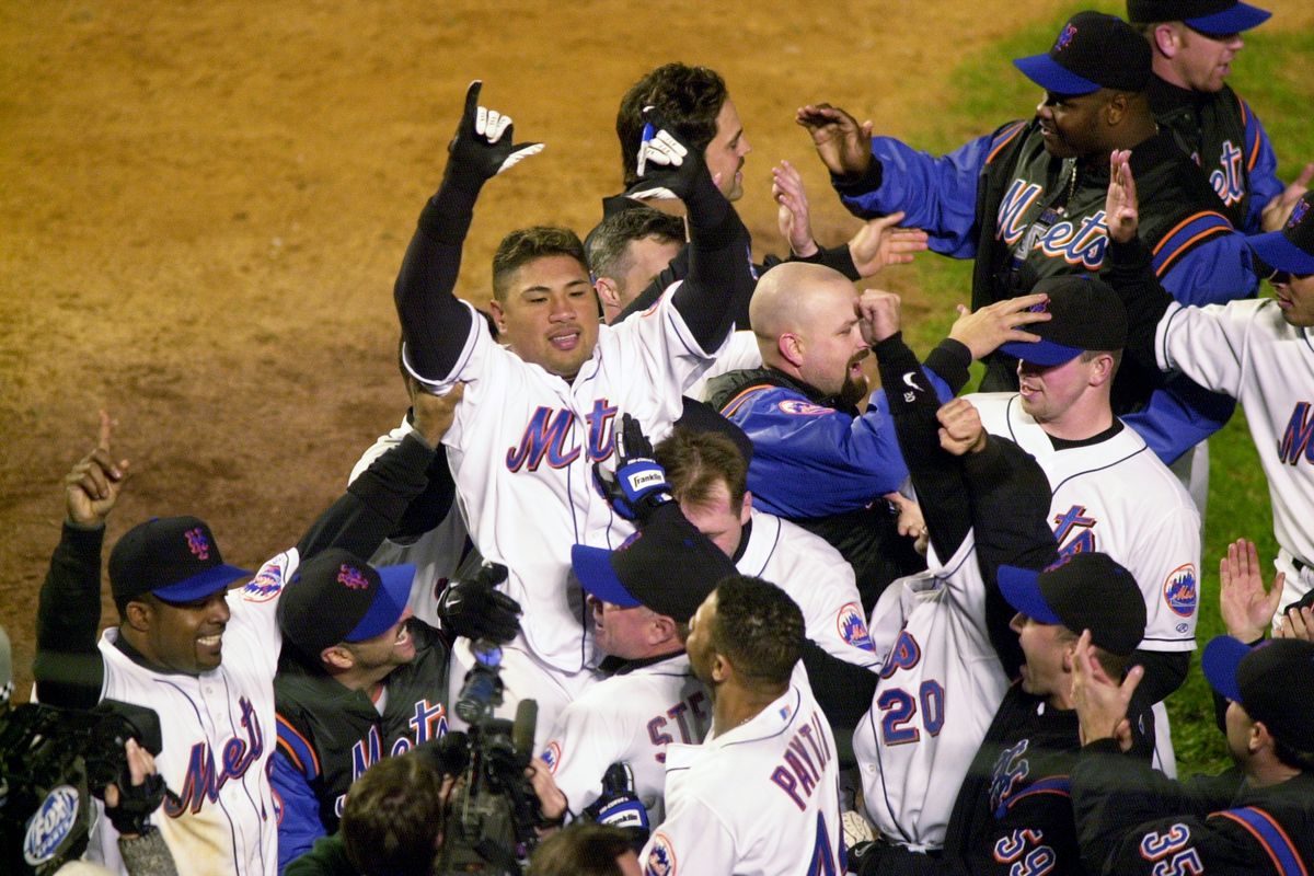 Mets players lift hero of the game, Benny Agbayani, in the a