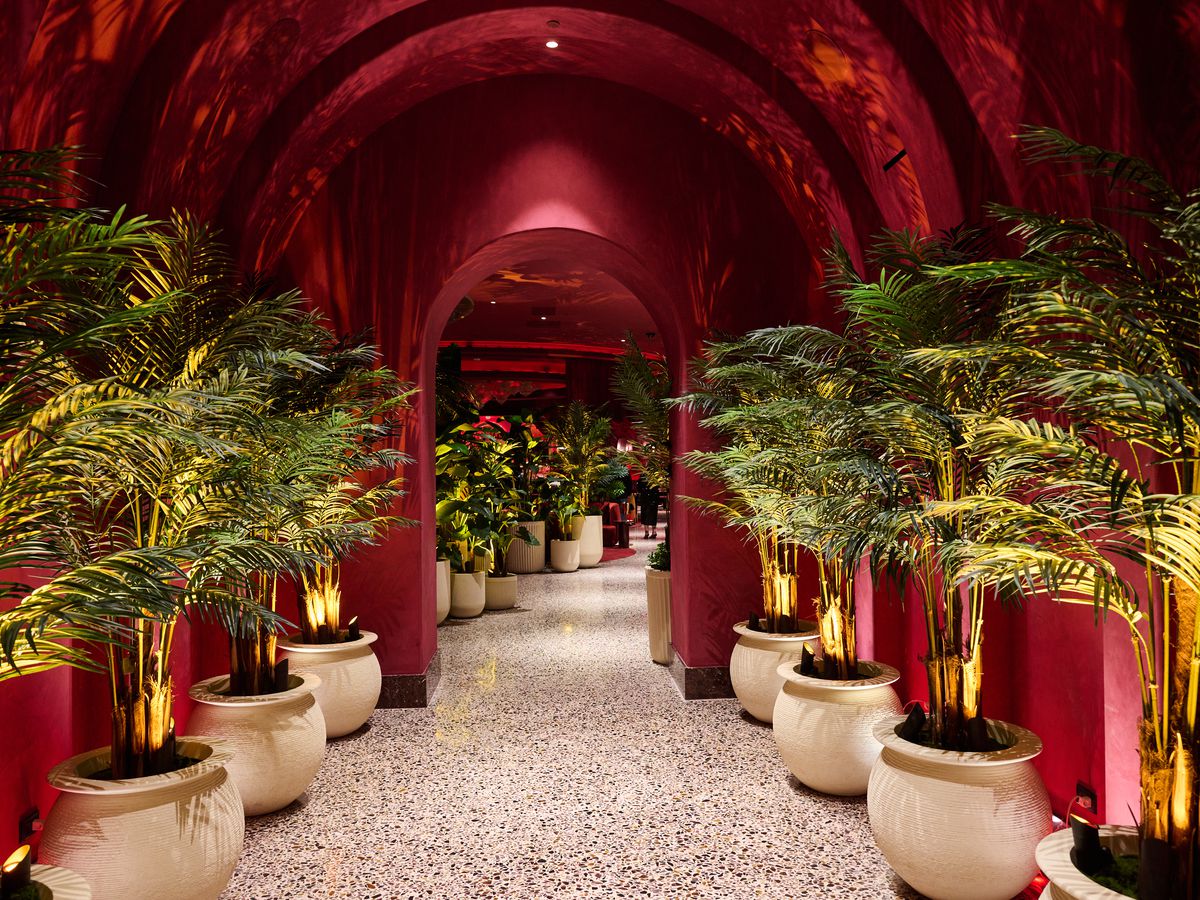 The red entry to Rouge Room with palm trees.