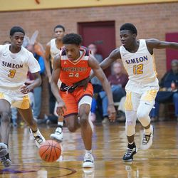 Brother Rice’s Marquise Kennedy (24) tries to keep the ball away from Simeon’s Antonio Reeves (3) and Simeon’s Ahamad Byunm (12), Friday 03-01-19. Worsom Robinson/For Sun-Times