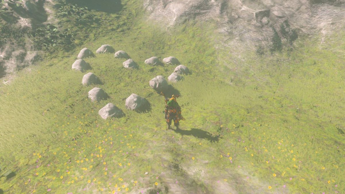 An image of Link in The Legend of Zelda: Breath of the Wild. He is standing in front of a series of rocks shaped like a heart.