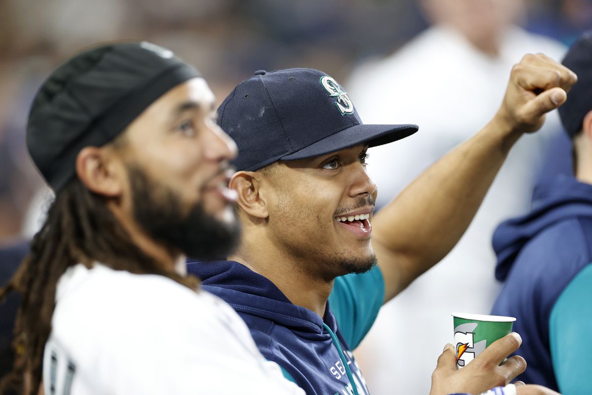 J.P. Crawford and Julio Rodriguez of the Seattle Mariners look on during the eighth inning against the Texas Rangers at T-Mobile Park on September 28, 2022 in Seattle, Washington.