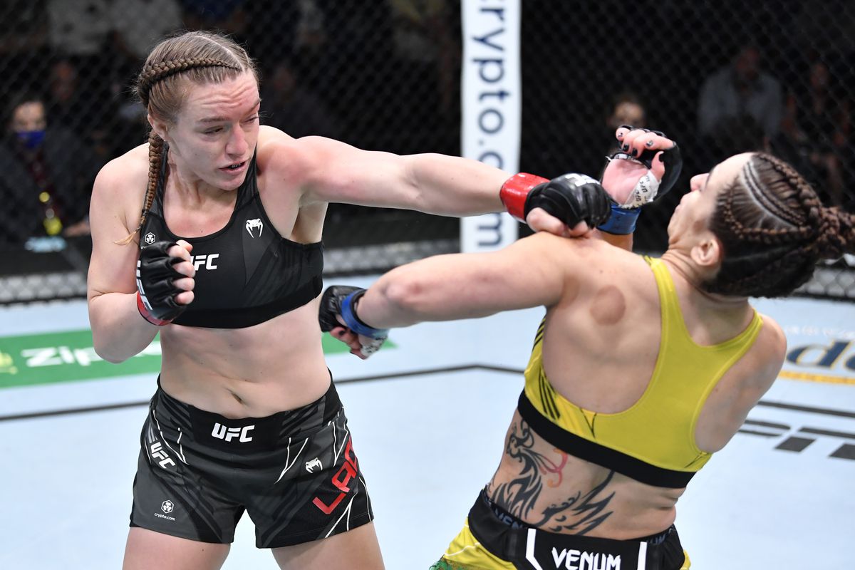 Aspen Ladd punches Norma Dumont of Brazil in a featherweight fight during the UFC Fight Night event at UFC APEX on October 16, 2021 in Las Vegas, Nevada.