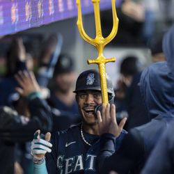 Seattle Mariners center fielder Julio Rodriguez (44) celebrates in in the dugout after hitting a two-run home run during the third inning against the Milwaukee Brewers at T-Mobile Park.