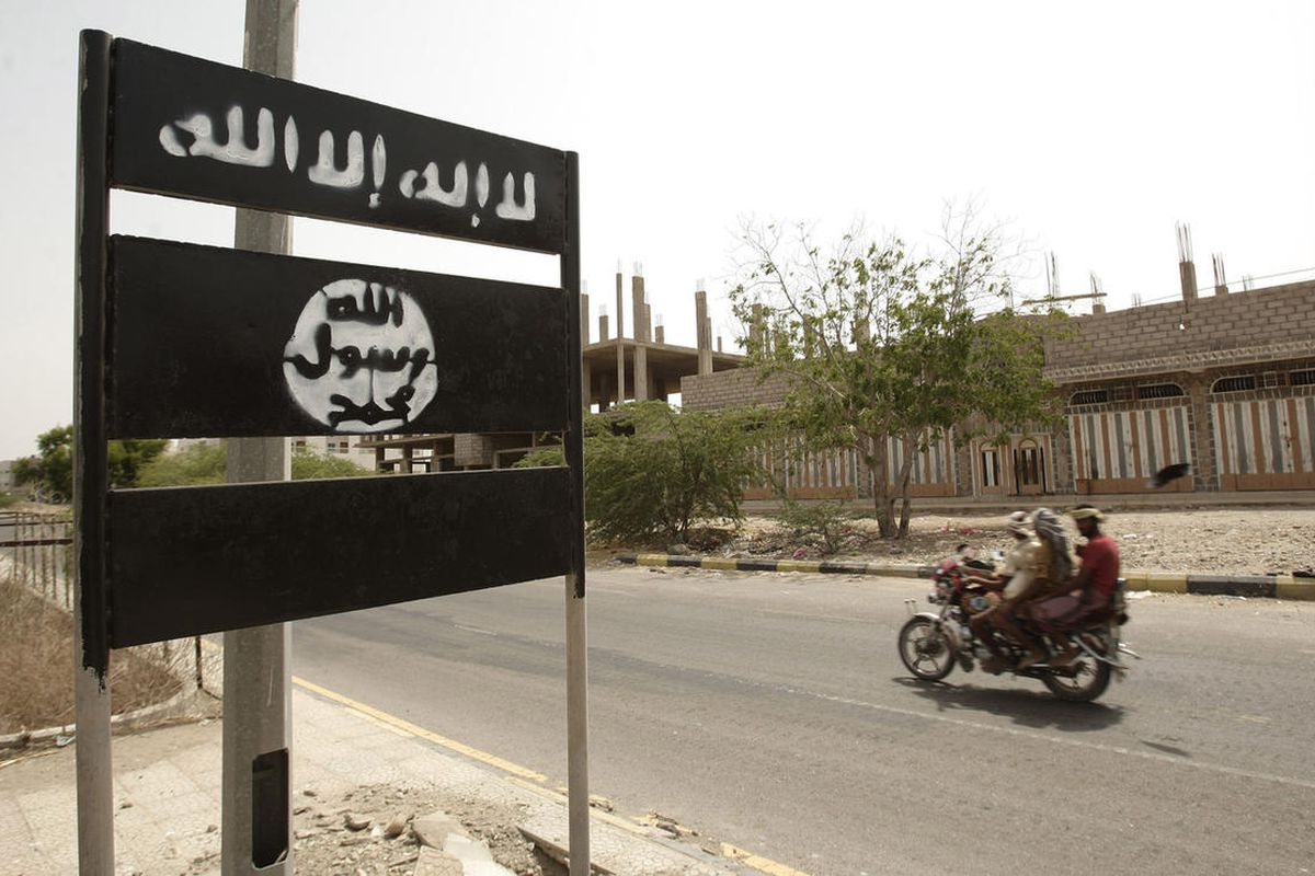 In this Friday, June 15, 2012 file photo, an al-Qaida logo is seen on a street sign in the town of Jaar in southern Abyan province, Yemen.