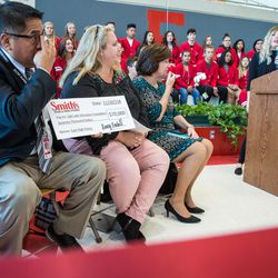 James Yapias, director of Salt Lake Education Foundation, left, receives a check from Smith's Food and Drug Stores during the opening East High School's Leopard Stash food pantry in Salt Lake City on Tuesday, Nov. 20, 2018. The grocery chain, part of the Kroger family of companies, donated the $5,000 help fight hunger elsewhere in the school district.
