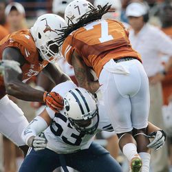 BYU's Sione Takitaki fights past a block to bring down Texas returner Marcus Johnson as BYU and Texas play Saturday, Sept. 6, 2014, in Austin Texas.