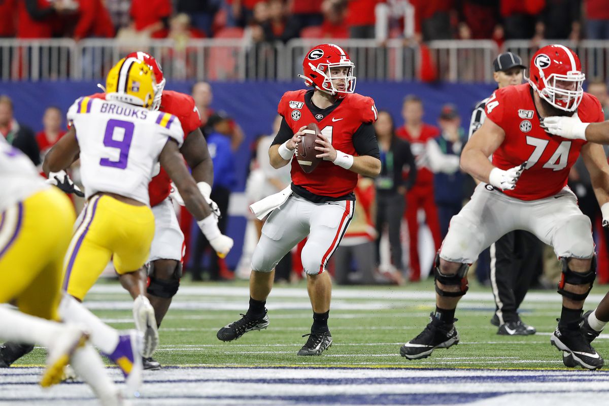 Jake Fromm of the Georgia Bulldogs looks to pass in the first half against the LSU Tigers during the SEC Championship game at Mercedes-Benz Stadium on December 07, 2019 in Atlanta, Georgia.