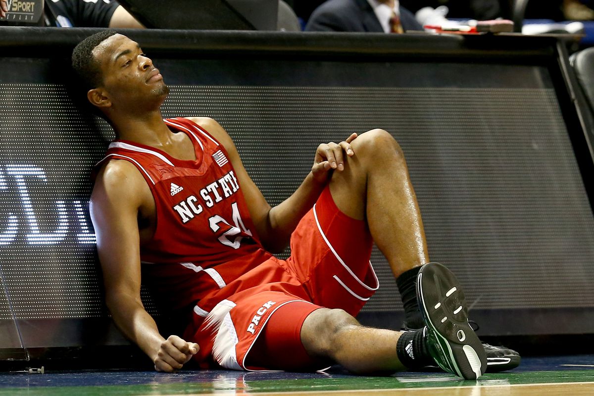GREENSBORO, NC - MARCH 15: T.J. Warren #24 of the North Carolina State Wolfpack falls on the sideline against the Duke Blue Devils during the semifinals of the 2014 Men's ACC Basketball Tournament at Greensboro Coliseum on March 15, 2014 in Greensbor