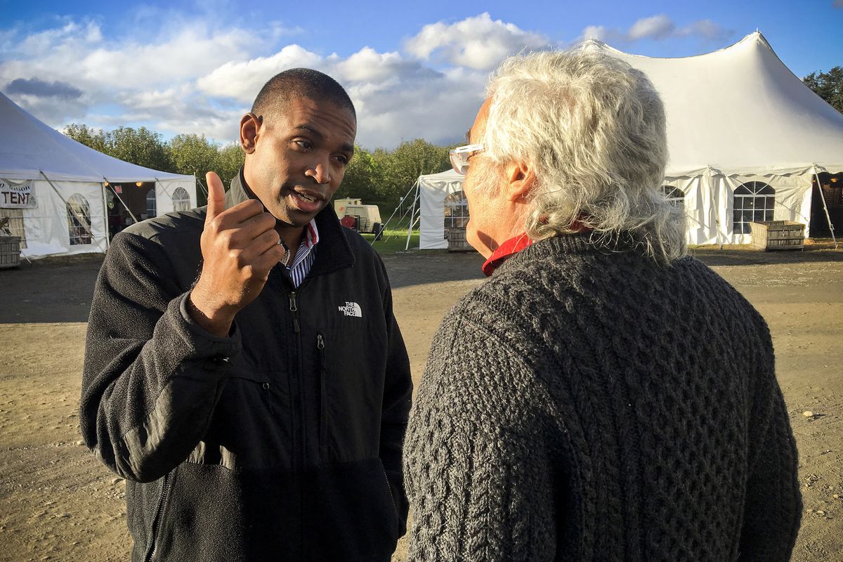 Congressional candidate Antonio Delgado talks with a potential voter while campaigning in Schodack Landing, N.Y., on October 13, 2018.