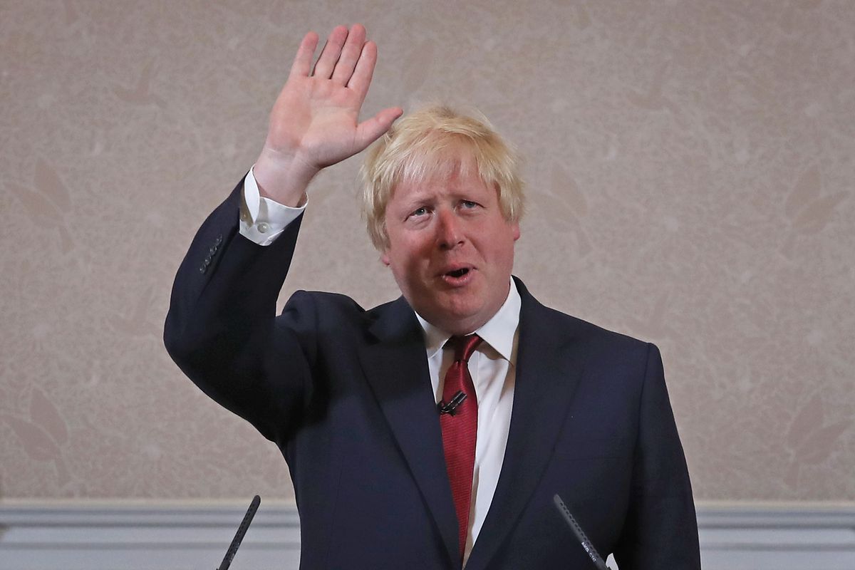 Boris Johnson waving at podium
