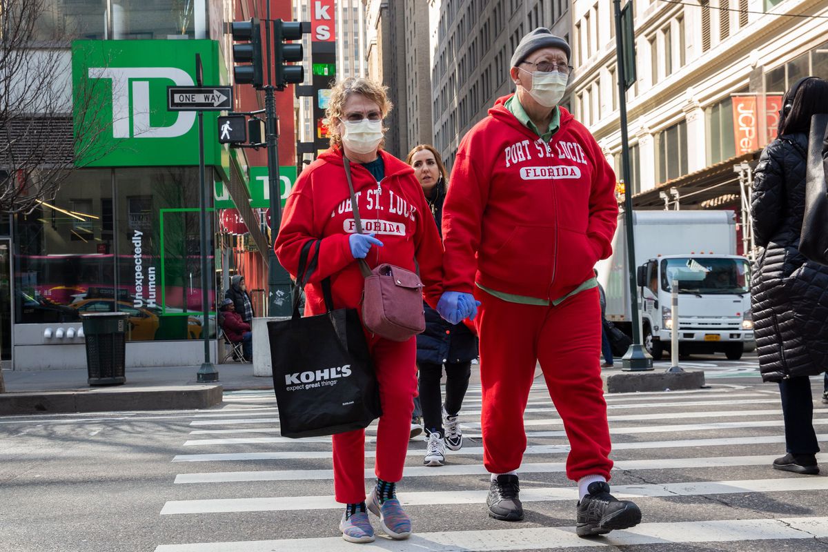 A couple wears masks and gloves while officials found the first case of Coronavirus in the city.