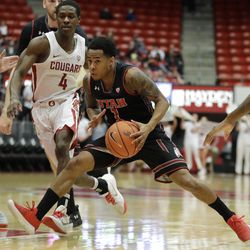 Utah guard Justin Bibbins (1) looks to pass as Washington State guard Viont'e Daniels 94) closes in during the first half of an NCAA college basketball game, Saturday, Feb. 17, 2018, in Pullman, Wash. (AP Photo/Ted S. Warren)