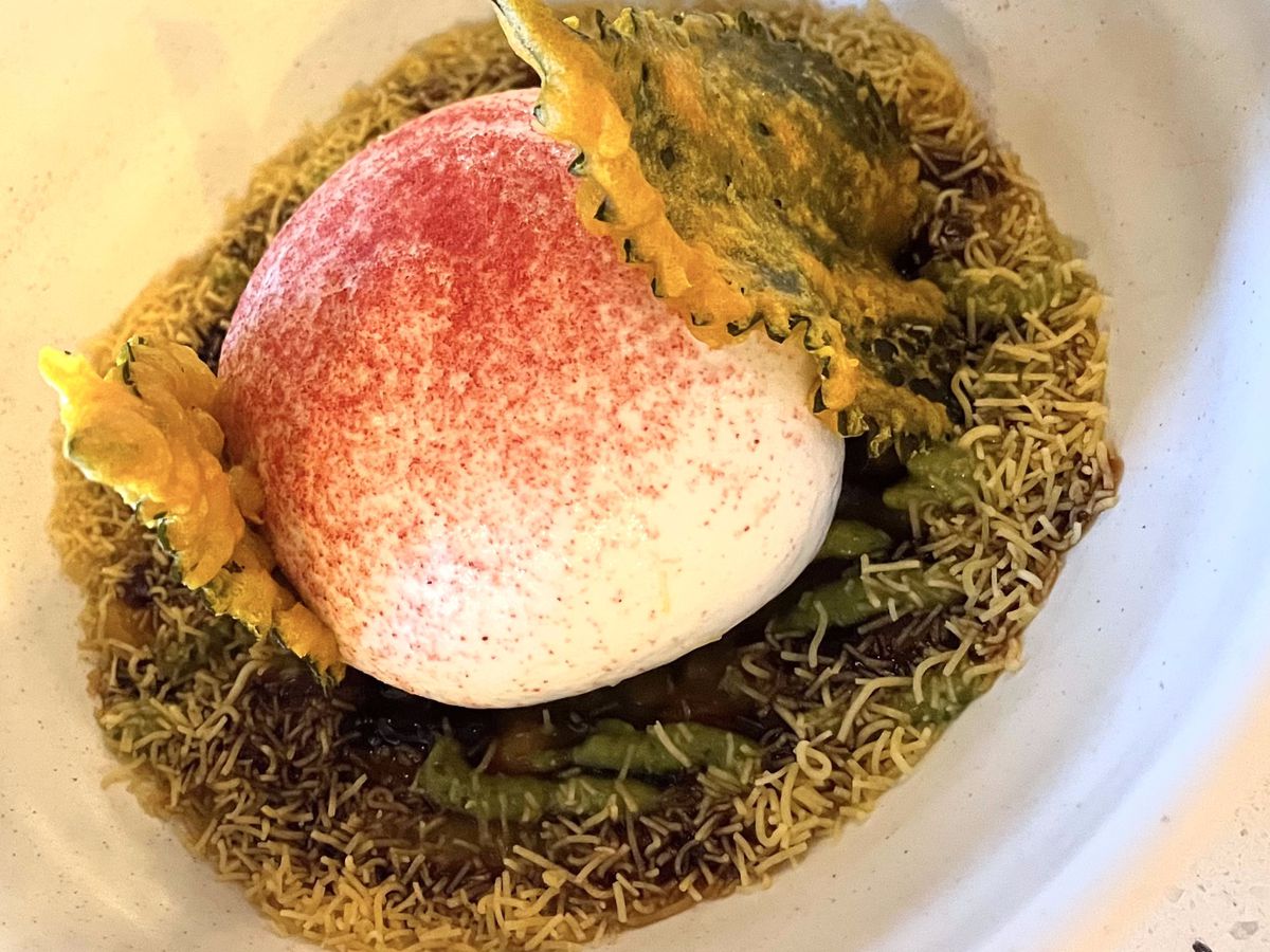 A bed of crispy noodles with yogurt mousse foam, dried raspberry powder, and crisp-fried shiso leaves.&nbsp;