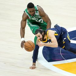 Utah Jazz guard Ricky Rubio (3) and Boston Celtics forward Semi Ojeleye (37) rush for a loose ball at Vivint Smart Home Arena in Salt Lake City on Wednesday, March 28, 2018.