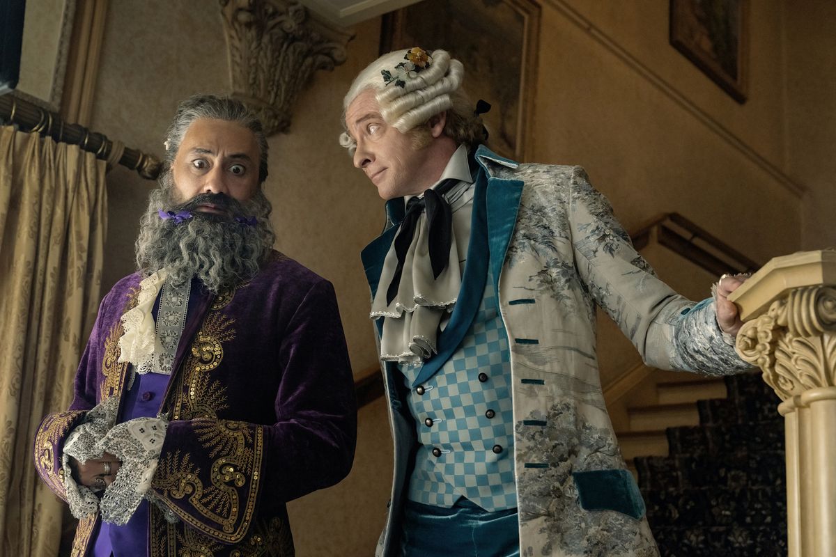 Taika Waititi and Rhys Darby dressed in formal attire in Our Flag Means Death.