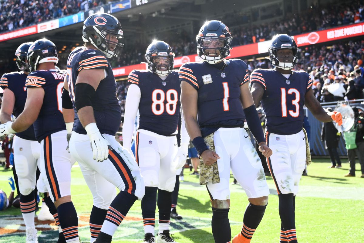 Bears quarterback Justin Fields (1) celebrates with Chicago Bears tight end Trevon Wesco (88) and Chicago Bears wide receiver Byron Pringle (13) after he scores a touchdown against the Detroit Lions during the first half at Soldier Field.&nbsp;